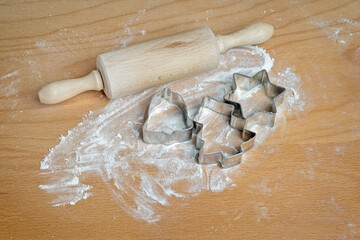 Christmas bakery with rolling pin silver cookie cutters scattered flour and kneaded dough