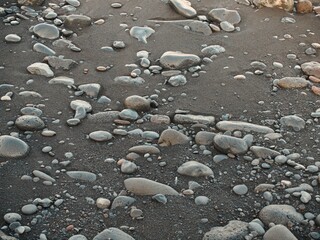Volcanic beach with black sand and pebbles
