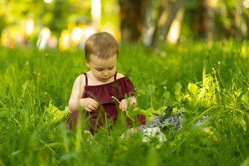 Gleeful in her outdoor play, the toddler's laughter merges with the chorus of a spring meadow. It's a snapshot of life's simple and pure moments.