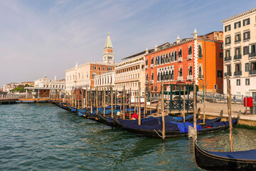 grand canal city in venice Italy with traditional gondolas port with church tower in turistic old town