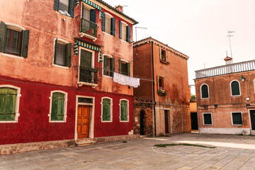 Italian mediterranean old town houses ocher color with clothes in facade