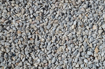 Small white and gray gravel on road closeup