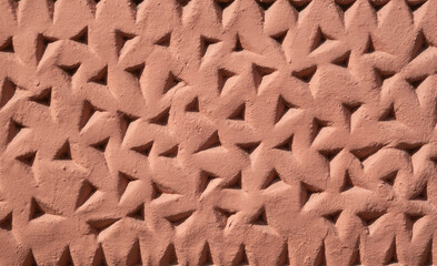 Decorative pink plaster with relief closeup