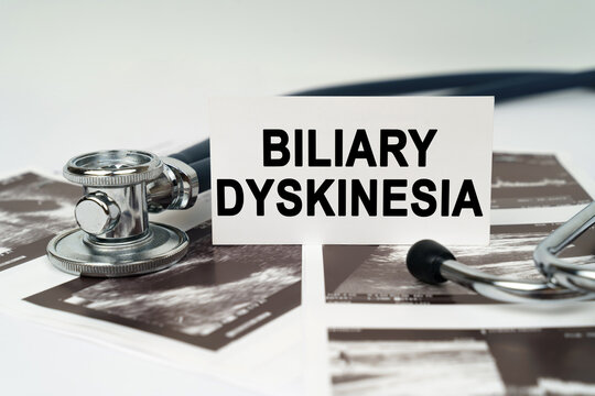 On the ultrasound pictures there is a stethoscope and a business card with the inscription - Biliary dyskinesia