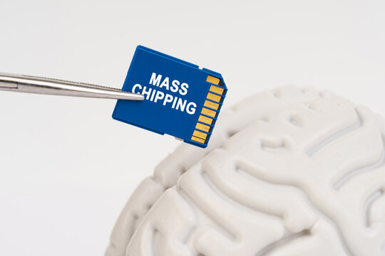 A man inserts a memory card into his brain with the inscription - mass chipping - Powered by Adobe
