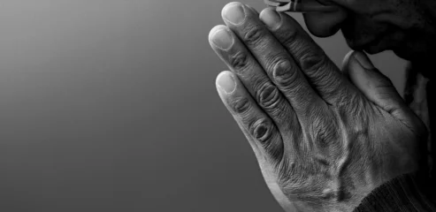 Foto op Plexiglas man praying to god on gray black background with people stock image stock photo © herlanzer