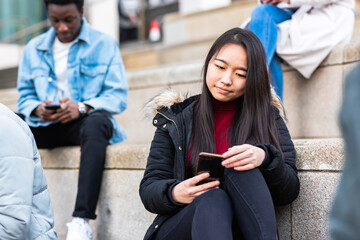 Multiracial millennial people using smart phones - 688097989