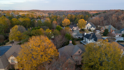 Fototapeta na wymiar Aerial panoramic view of an upscale subdivision in suburbs of USA shot during golden hour in December 2023