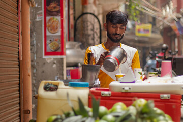Male street vendor making fruit juice at his juice shop