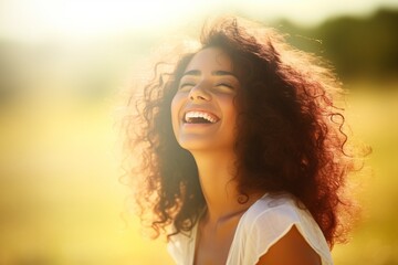 Woman with Curly Hair Smiling in a Field