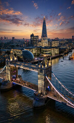 Beautiful aerial view of the illuminated Tower Bridge and skyline of London, UK, just after sunset - 688102558