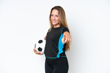 Young caucasian woman isolated on white background with soccer ball and pointing to the front
