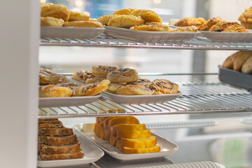 Fresh pastries on display, morning breakfast sweet food background, copy space image