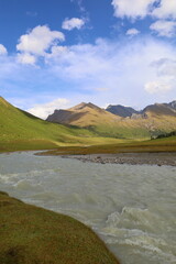 Ak-Suu river wading on fifth stage of Ak-Suu Traverse trek in Tian Shan mountains, Karakol, Kyrgyzstan