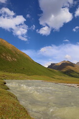 Ak-Suu river wading on fifth stage of Ak-Suu Traverse trek in Tian Shan mountains, Karakol, Kyrgyzstan