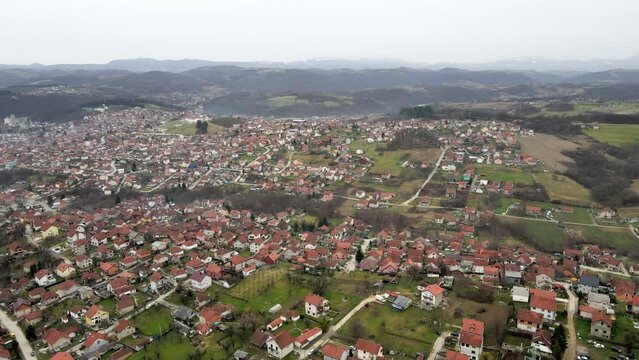 A drone captures a stunning aerial shot of a hilly area adorned with houses in Valjevo