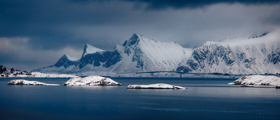 Dramatic winter scene of Lofoten Islands with Fredvang bridge on background. Panoramic morning view...