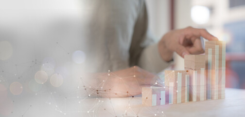 businessman planing and using holographic in the office workplace for work progress about investment and money management with trading chart  financial plan to making and calculate passive incomes 