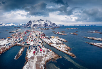 Dramatic winter view from flying drone of Henningsvaer town. Aerial seascape of Norwegian sea, Lofoten Islands, Norway, Europe. Traveling concept background. Life over polar circle.