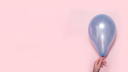 Pastel blue balloon with female hand. Lightness concept. Banner for YouTube. from copy space
