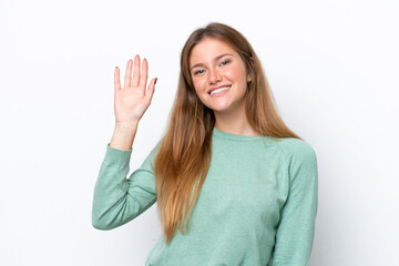 Young caucasian woman isolated on white background saluting with hand with happy expression © luismolinero