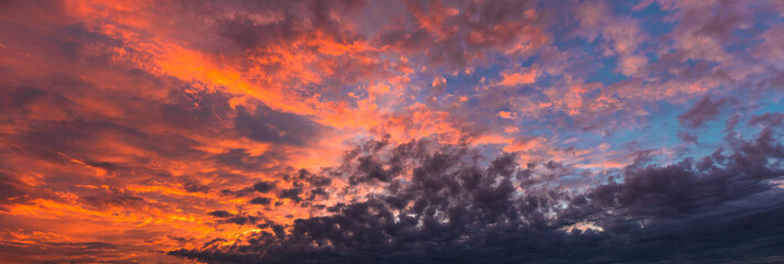 Beautiful sunset sky. Pink and orange fluffy clouds. Atmospheric natural background.