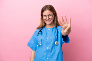 Young surgeon doctor woman isolated on pink background happy and counting four with fingers