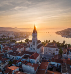 Amazing panoramic view of the picturesque town of Trogir in Croatia, the old town with beautiful historic buildings bathed in morning light, at the Adriatic Sea coast.