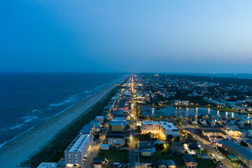 an aerial shot along the coastline of the Atlantic ocean with blue water, a sandy beach, hotels and...