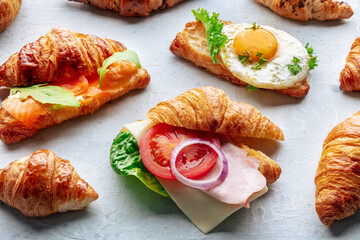 Croissant sandwich assortment. Various stuffed croissants. Rolls filled with ham, salmon, egg, etc