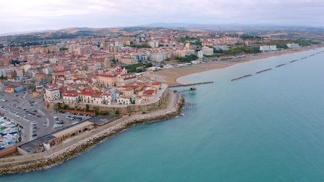 4k drone forward video (Ultra High Definition) of Sant'Antonio beach. Spectacular morning cityscape of Termoli port. Splendid sunrise on Adriatic sea. Traveling concept background.