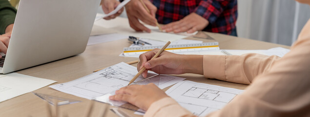 Professional architect drawing blueprint during meeting at modern architectural office on table...
