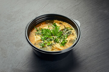 Traditional Korean food, kimchi soup with kimchi and tofu in plastic bowl