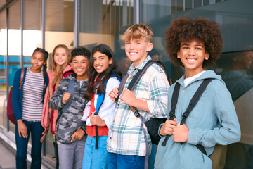 Portrait Showing Class Of Secondary Or High School Pupils Standing Outside School Building