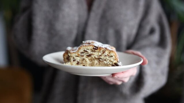 Woman hold plate with german stollen at home, Poland