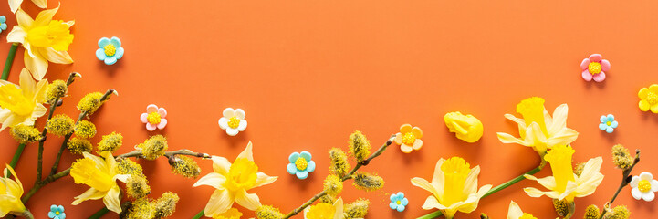 Festive Easter background with yellow daffodils and decorative ornaments, Happy Easter banner