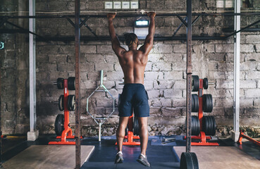 Unrecognizable black man athlete doing abs exercise on horizontal bar