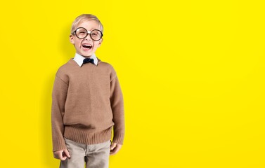 Photo of cool school boy posing on color background