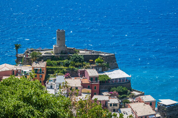 Architecture of Vernazza village with Doria castle on top and turquoise sea, ITALY