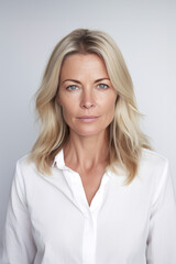 Obraz premium Beautiful blonde woman in her 40s, portrait studio shot on white background, good-looking successful caucasian woman.