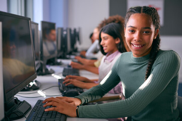 Portrait Of Female Secondary Or High School Student Sitting At Computer Screen In IT Class 