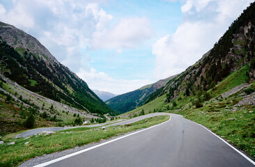 Asphalt road in Alps mountains. Road trip concept. Beautiful landscape.
