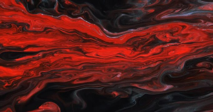 Moving streams of red paint with blue streaks on a dark abstract background, screensaver. The texture of marble. Abstract art. A moving drawing. Liquid abstraction.
