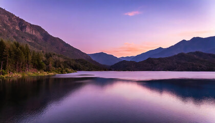 lake surrounded by forested mountains under a purple sky at sunset