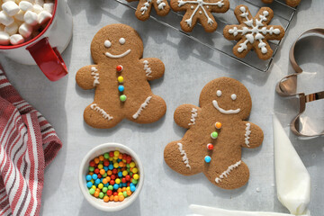 Baking and decorating gingerbread man cookies for a winter holiday Christmas party