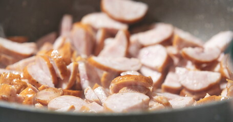 Sausage cuts frying on pan