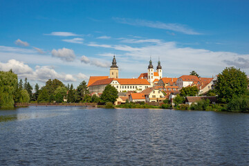 Fototapeta na wymiar Telc, a town in Moravia in the Czech Republic. Water reflection of houses and Telc Castle, Czech Republic. UNESCO World Heritage Site.
