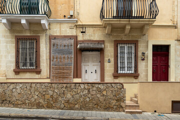 A facade of a typical, Maltese limestone residential building
