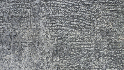 A gray grunge picturesque asphalt texture with stains and scratches on concrete surface 