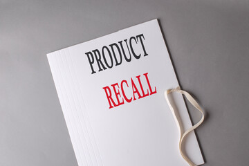 PRODUCT RECALL text on white folder on grey background